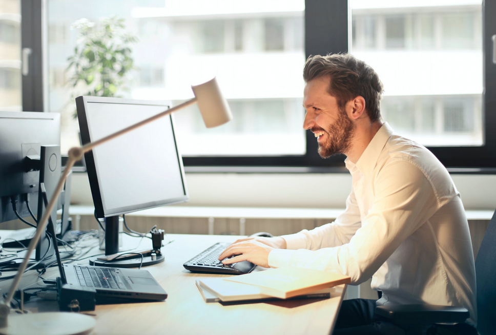 man in office using computer